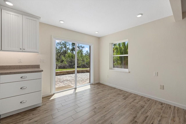 6718 68th Ave E, Bradenton, FL 34203 - unfurnished dining area featuring baseboards, recessed lighting, and light wood-style floors