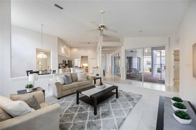 8824 Havenridge Dr, Sarasota, FL 34238 - living room featuring high vaulted ceiling, ceiling fan, light tile patterned floors, a textured ceiling, and visible vents