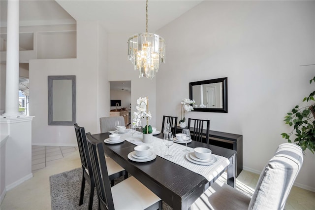 8824 Havenridge Dr, Sarasota, FL 34238 - dining space featuring high vaulted ceiling, baseboards, ornate columns, and an inviting chandelier