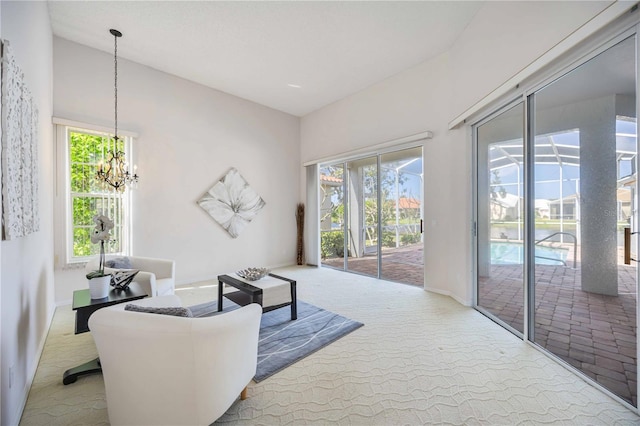 8824 Havenridge Dr, Sarasota, FL 34238 - carpeted living room featuring a chandelier