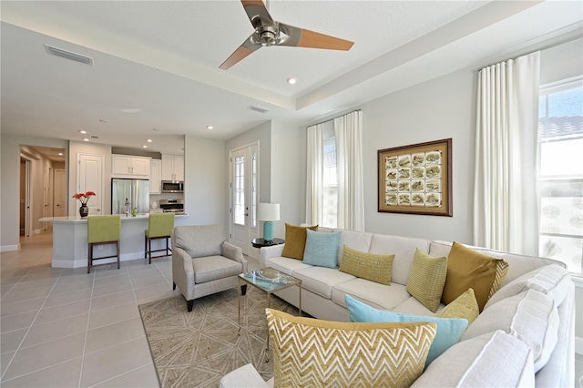 living area with visible vents, recessed lighting, light tile patterned floors, and a ceiling fan