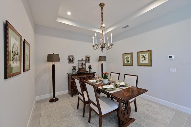 dining area featuring a tray ceiling, light tile patterned flooring, baseboards, and recessed lighting