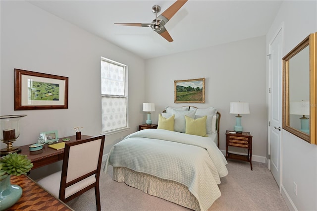 bedroom with light carpet, ceiling fan, and baseboards