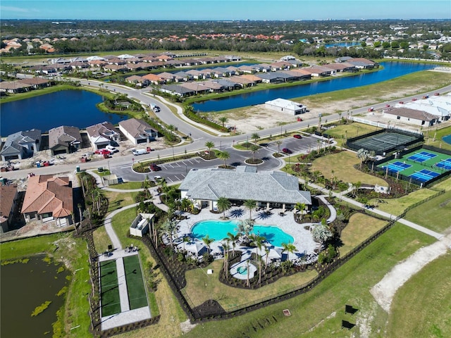 drone / aerial view featuring a water view and a residential view