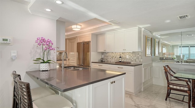 99 Sunset Dr Unit 102, Sarasota, FL 34236 - kitchen featuring high end fridge, a sink, dark countertops, recessed lighting, and a peninsula