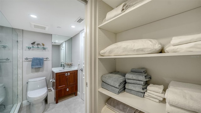 99 Sunset Dr Unit 102, Sarasota, FL 34236 - bathroom with toilet, a stall shower, vanity, tile patterned floors, and recessed lighting
