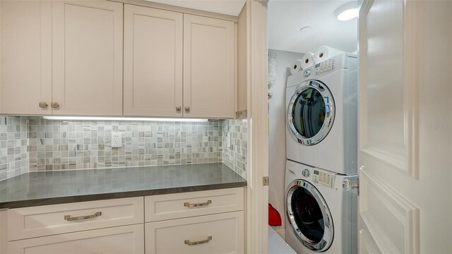 99 Sunset Dr Unit 102, Sarasota, FL 34236 - laundry area featuring stacked washer / drying machine and cabinet space
