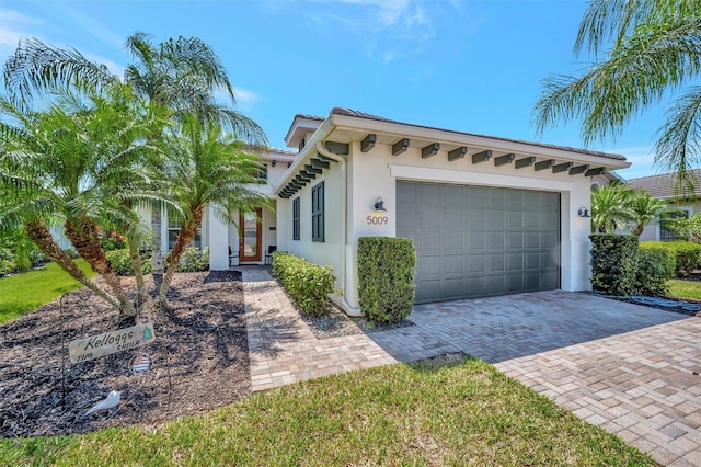 5009 Lake Overlook Ave, Bradenton, FL 34208 - view of front facade with an attached garage, driveway, and stucco siding