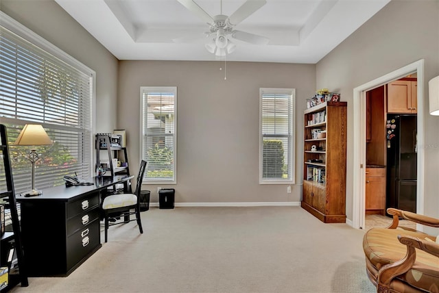 5009 Lake Overlook Ave, Bradenton, FL 34208 - office area featuring light colored carpet, a ceiling fan, a raised ceiling, and baseboards