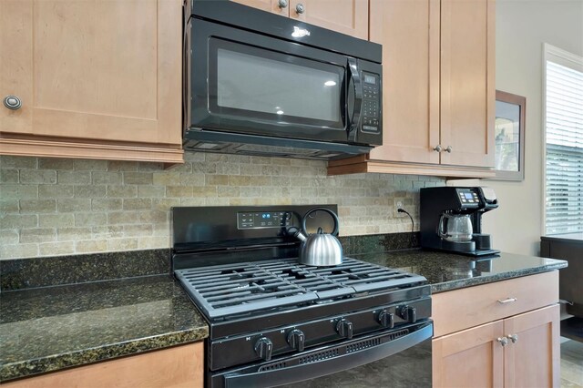 5009 Lake Overlook Ave, Bradenton, FL 34208 - kitchen featuring a wealth of natural light, black appliances, decorative backsplash, and dark stone counters