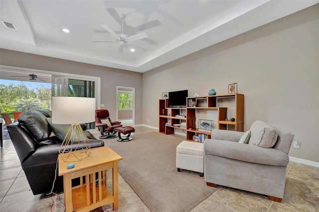 5009 Lake Overlook Ave, Bradenton, FL 34208 - living room featuring a tray ceiling, baseboards, a ceiling fan, and visible vents
