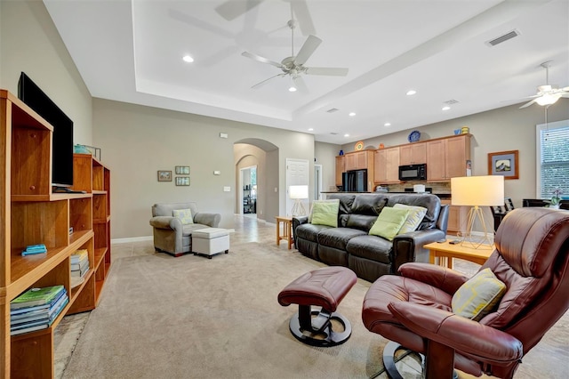 5009 Lake Overlook Ave, Bradenton, FL 34208 - living room featuring arched walkways, a ceiling fan, visible vents, recessed lighting, and a raised ceiling