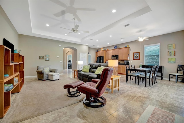 5009 Lake Overlook Ave, Bradenton, FL 34208 - living room featuring a tray ceiling, a ceiling fan, arched walkways, and recessed lighting