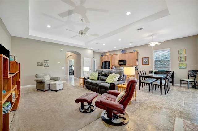 5009 Lake Overlook Ave, Bradenton, FL 34208 - living area featuring visible vents, a ceiling fan, arched walkways, and a raised ceiling