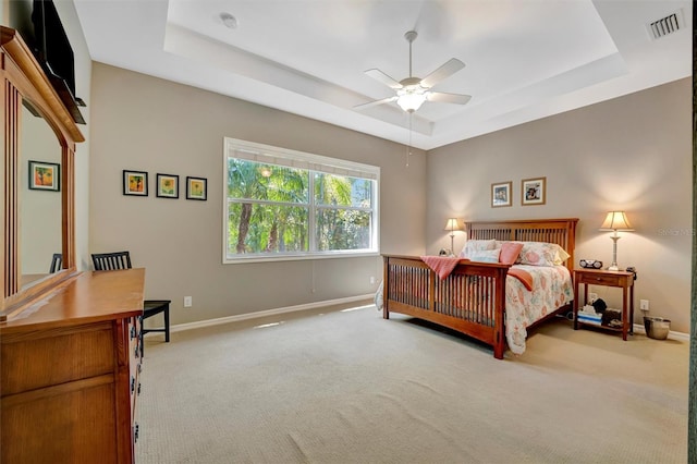 5009 Lake Overlook Ave, Bradenton, FL 34208 - bedroom with baseboards, visible vents, a tray ceiling, ceiling fan, and carpet