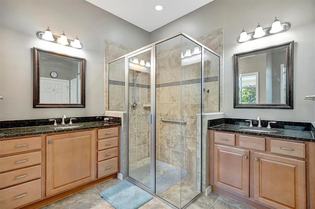 5009 Lake Overlook Ave, Bradenton, FL 34208 - bathroom featuring a shower stall, tile patterned floors, two vanities, and a sink