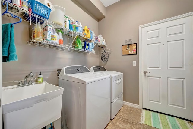 5009 Lake Overlook Ave, Bradenton, FL 34208 - clothes washing area with baseboards, light tile patterned flooring, independent washer and dryer, laundry area, and a sink