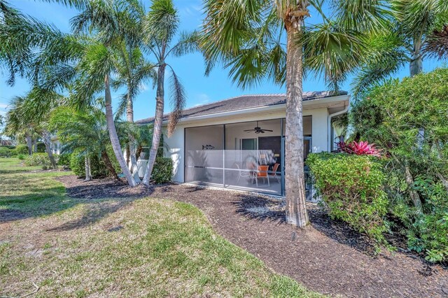 5009 Lake Overlook Ave, Bradenton, FL 34208 - exterior space featuring a yard, ceiling fan, a sunroom, and stucco siding
