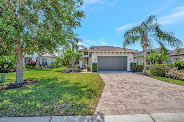 5009 Lake Overlook Ave, Bradenton, FL 34208 - view of front of home featuring a tiled roof, stucco siding, decorative driveway, a front lawn, and an attached garage