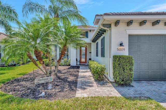 5009 Lake Overlook Ave, Bradenton, FL 34208 - entrance to property with a garage, stucco siding, and a tiled roof