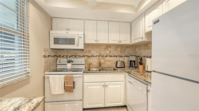 4350 Chatham Dr Unit E-105, Longboat Key, FL 34228 - kitchen featuring white appliances, a sink, tasteful backsplash, white cabinets, and light stone countertops