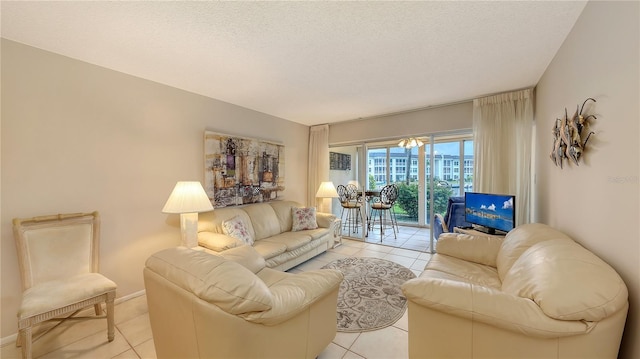 4350 Chatham Dr Unit E-105, Longboat Key, FL 34228 - living room featuring light tile patterned floors and a textured ceiling