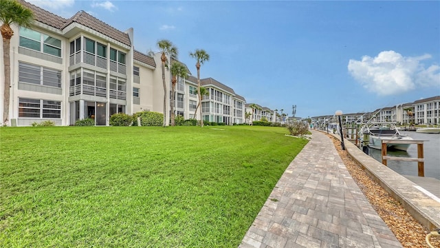 4350 Chatham Dr Unit E-105, Longboat Key, FL 34228 - view of community featuring a lawn, a dock, a residential view, and a water view