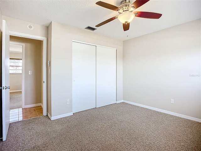 2705 21st Ave W, Bradenton, FL 34205 - unfurnished bedroom with visible vents, a ceiling fan, carpet floors, a closet, and baseboards