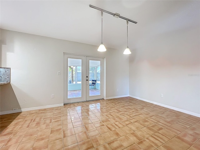 2705 21st Ave W, Bradenton, FL 34205 - spare room with baseboards, light tile patterned floors, and french doors
