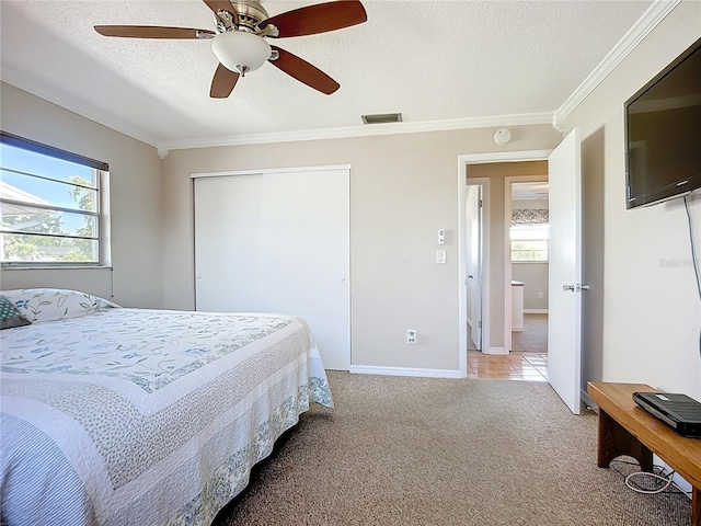 2705 21st Ave W, Bradenton, FL 34205 - carpeted bedroom with a closet, visible vents, a textured ceiling, and ornamental molding
