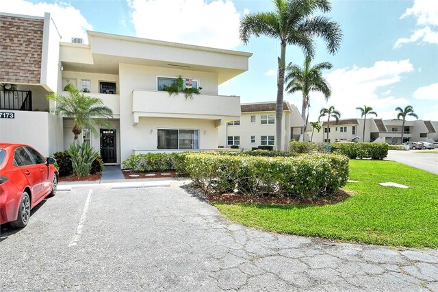 7173 W Country Club Dr N Unit 141, Sarasota, FL 34243 - view of building exterior featuring uncovered parking