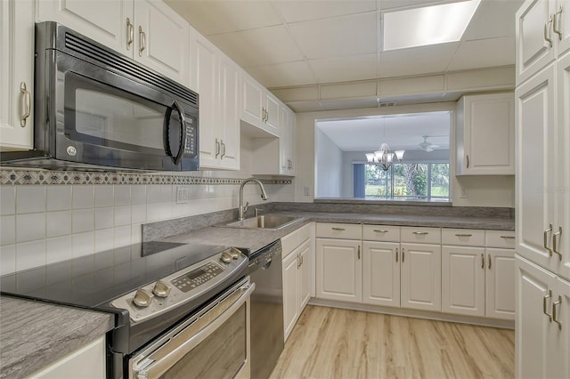 7173 W Country Club Dr N Unit 141, Sarasota, FL 34243 - kitchen with a sink, white cabinets, appliances with stainless steel finishes, and light wood-style flooring