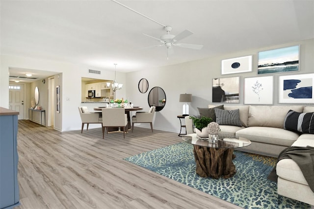 7173 W Country Club Dr N Unit 141, Sarasota, FL 34243 - living area with baseboards, light wood-style flooring, ceiling fan with notable chandelier, and visible vents