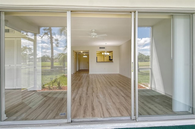 7173 W Country Club Dr N Unit 141, Sarasota, FL 34243 - entryway with baseboards, ceiling fan with notable chandelier, and wood finished floors