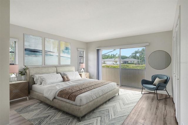 7173 W Country Club Dr N Unit 141, Sarasota, FL 34243 - bedroom with access to outside and wood finished floors