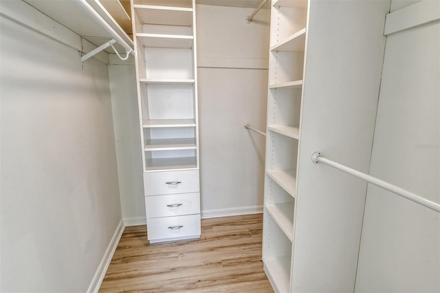 7173 W Country Club Dr N Unit 141, Sarasota, FL 34243 - walk in closet featuring wood finished floors