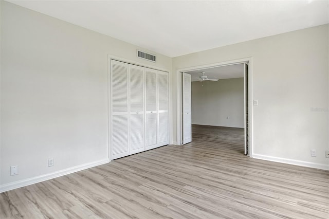7173 W Country Club Dr N Unit 141, Sarasota, FL 34243 - unfurnished bedroom with visible vents, baseboards, light wood finished floors, and a closet