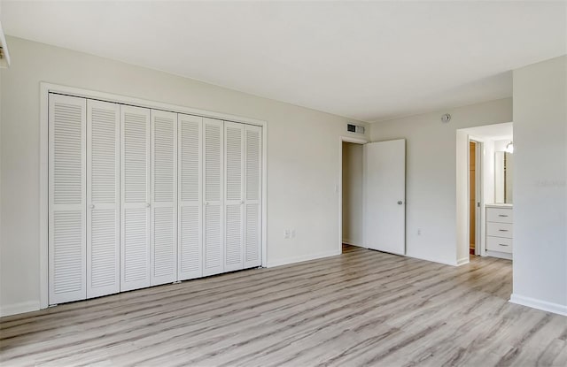 7173 W Country Club Dr N Unit 141, Sarasota, FL 34243 - unfurnished bedroom featuring visible vents, baseboards, light wood finished floors, and a closet