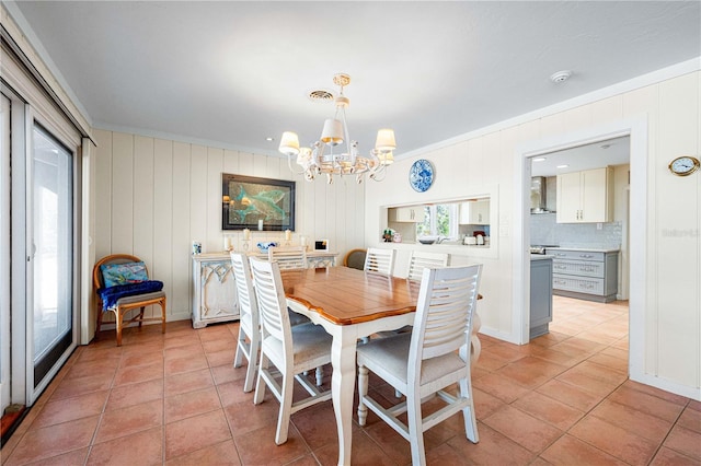 8592 Hidden Lagoon Rd, Sarasota, FL 34242 - dining room featuring a chandelier, light tile patterned flooring, and crown molding