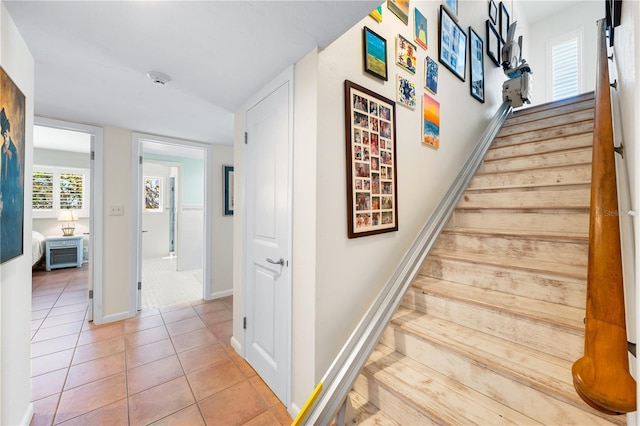 8592 Hidden Lagoon Rd, Sarasota, FL 34242 - staircase featuring tile patterned floors and baseboards