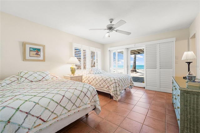 8592 Hidden Lagoon Rd, Sarasota, FL 34242 - bedroom with access to exterior, tile patterned floors, a ceiling fan, and a water view