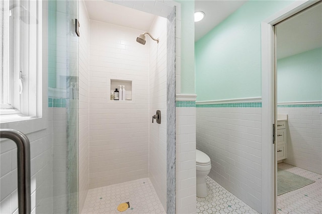 8592 Hidden Lagoon Rd, Sarasota, FL 34242 - bathroom featuring a shower stall, a wainscoted wall, tile walls, and tile patterned floors