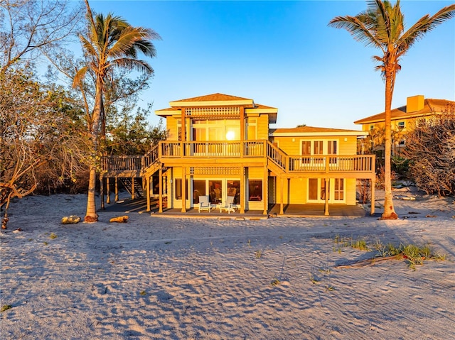 8592 Hidden Lagoon Rd, Sarasota, FL 34242 - back of property with a wooden deck, stairs, and a patio area
