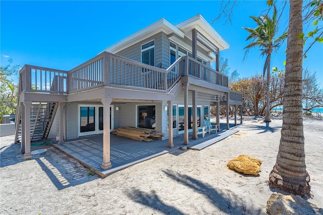 8592 Hidden Lagoon Rd, Sarasota, FL 34242 - back of property featuring a patio area, stairs, and a deck