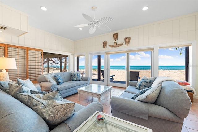 8592 Hidden Lagoon Rd, Sarasota, FL 34242 - living room with light tile patterned floors, view of water and beach, ceiling fan, healthy amount of natural light, and recessed lighting