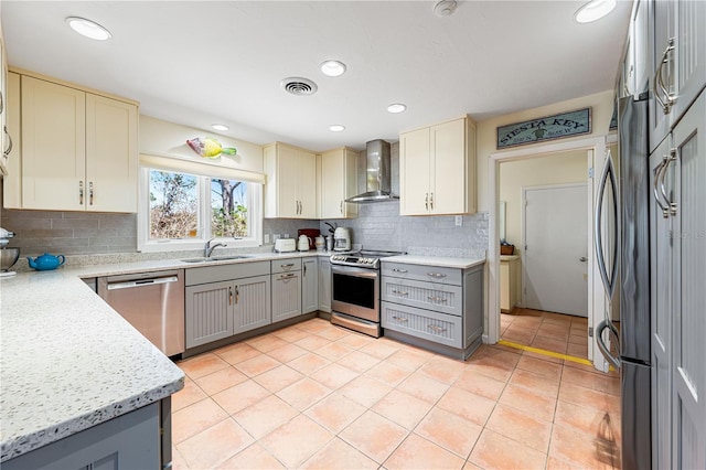 8592 Hidden Lagoon Rd, Sarasota, FL 34242 - kitchen featuring appliances with stainless steel finishes, gray cabinets, wall chimney exhaust hood, decorative backsplash, and light tile patterned floors