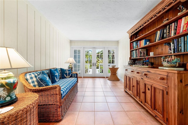 8592 Hidden Lagoon Rd, Sarasota, FL 34242 - living area featuring french doors, light tile patterned flooring, a textured ceiling, and wooden walls