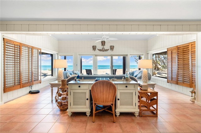 8592 Hidden Lagoon Rd, Sarasota, FL 34242 - home office with light tile patterned flooring, ceiling fan, a water view, crown molding, and wooden walls