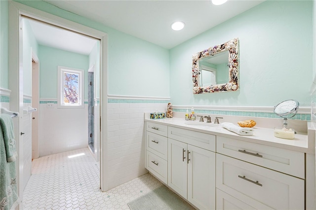 8592 Hidden Lagoon Rd, Sarasota, FL 34242 - full bath featuring tile walls, vanity, a wainscoted wall, and a stall shower