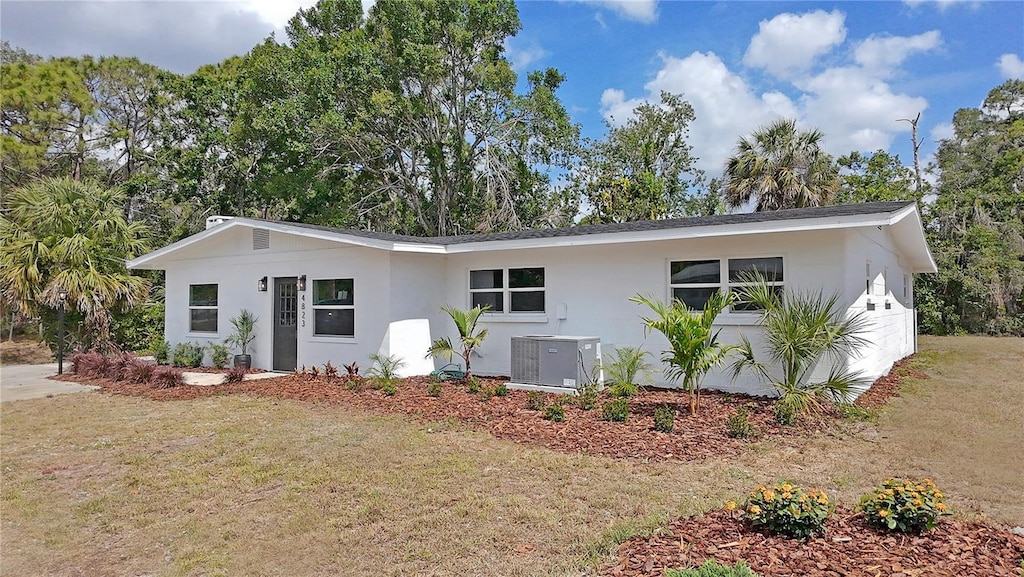 4823 Linwood St, Sarasota, FL 34232 - ranch-style house with central AC unit, stucco siding, and a front lawn